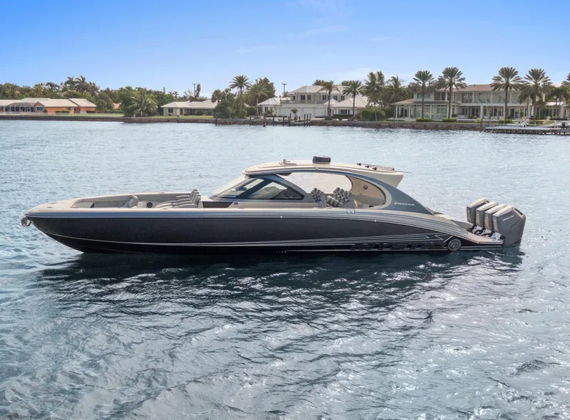 Slide: The Image of 2024 Mystic Powerboats M5200 luxury boat on calm water, with modern design and powerful engines. - 40