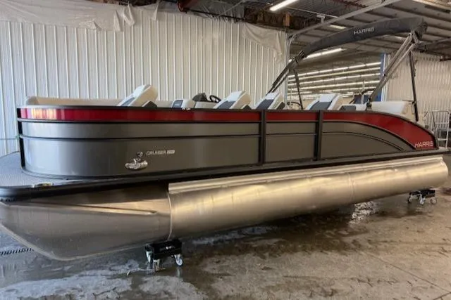 The Image of 2025 Harris Cruiser 230 pontoon boat in a storage facility. - 0