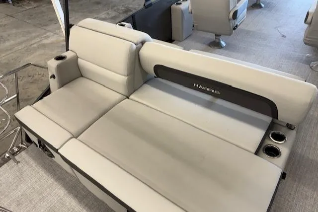 Slide: The Image of 2025 Harris Cruiser 230 boat interior with beige seating and cup holders. - 11