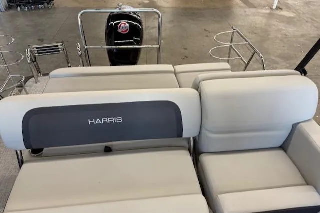 Slide: The Image of 2025 Harris Cruiser 230 boat interior with plush seating and motor view. - 12