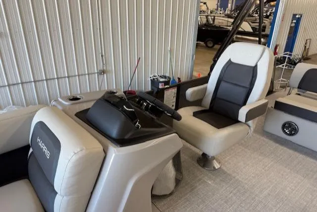 Slide: The Image of 2025 Harris Cruiser 230 boat interior with modern seating and steering console. - 14