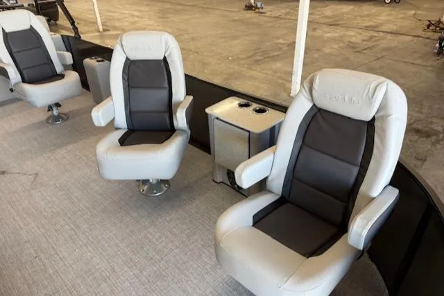 Slide: The Image of Luxury seating on 2025 Harris Cruiser 230 boat, featuring plush armchairs and cup holders. - 15