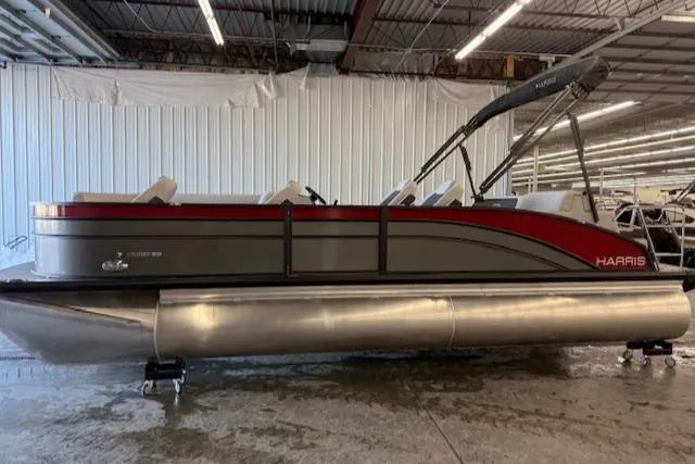 Slide: The Image of 2025 Harris Cruiser 230 pontoon boat in a warehouse setting. - 17