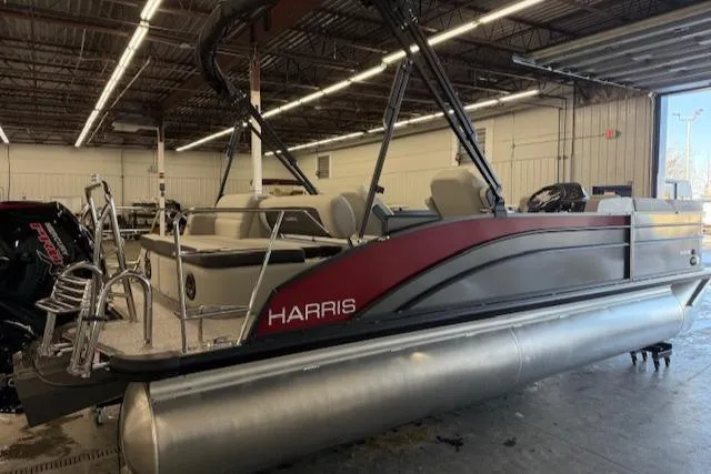 Slide: The Image of 2025 Harris Cruiser 230 pontoon boat in a warehouse setting. - 2