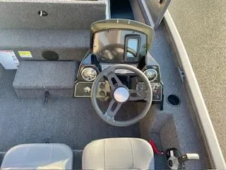 Slide: The Image of 2025 Lowe 175 Stinger boat interior with steering wheel and dashboard controls. - 10