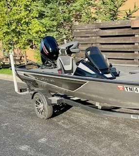 Slide: The Image of 2025 Lowe 175 Stinger boat on trailer, parked outdoors. - 3