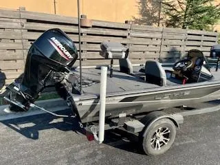 Slide: The Image of 2025 Lowe 175 Stinger boat with Mercury engine, parked on a trailer. - 4