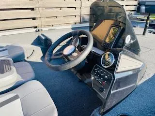 Slide: The Image of 2025 Lowe 175 Stinger boat dashboard with steering wheel and control panel. - 5