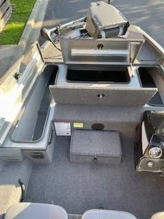 Slide: The Image of 2025 Lowe 175 Stinger boat interior with open storage compartments and seating. - 9