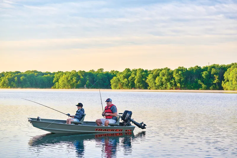 Slide: The Image of Manufacturer Provided Image: Two people fishing on a 2026 Tracker Grizzly 12 Jon boat in a serene lake. - 14