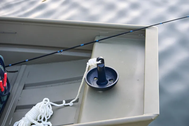 Slide: The Image of Manufacturer Provided Image: 2026 Tracker Grizzly 12 Jon boat with fishing rod and anchor on calm water. - 18