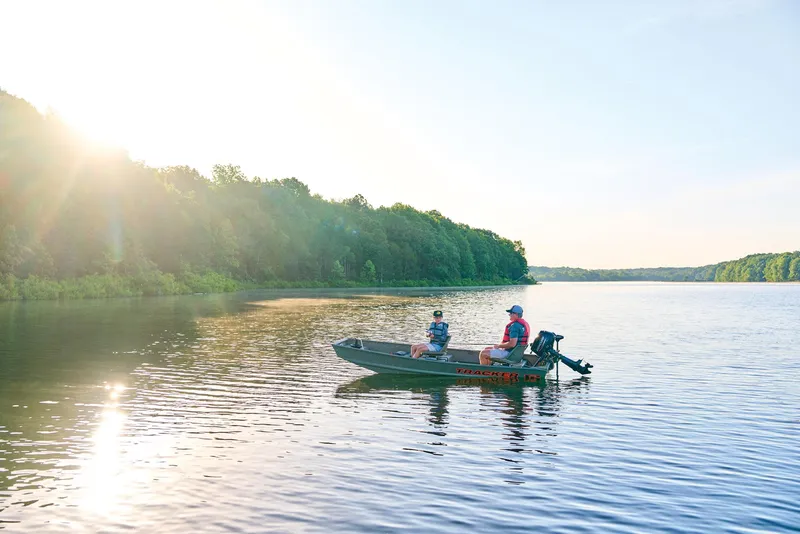 Slide: The Image of Manufacturer Provided Image: Two people fishing on a 2026 Tracker Grizzly 12 Jon boat in a serene lake. - 20