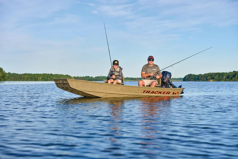 Slide: The Image of Manufacturer Provided Image: Two people fishing on a 2026 Tracker Grizzly 12 Jon boat in a serene lake. - 21