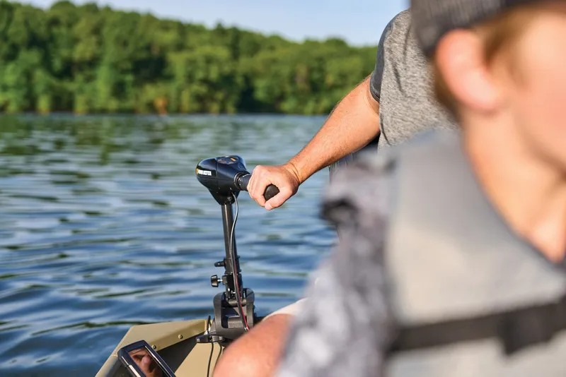 Slide: The Image of Manufacturer Provided Image: Man steering 2026 Tracker Grizzly 12 Jon boat on a calm lake. - 23