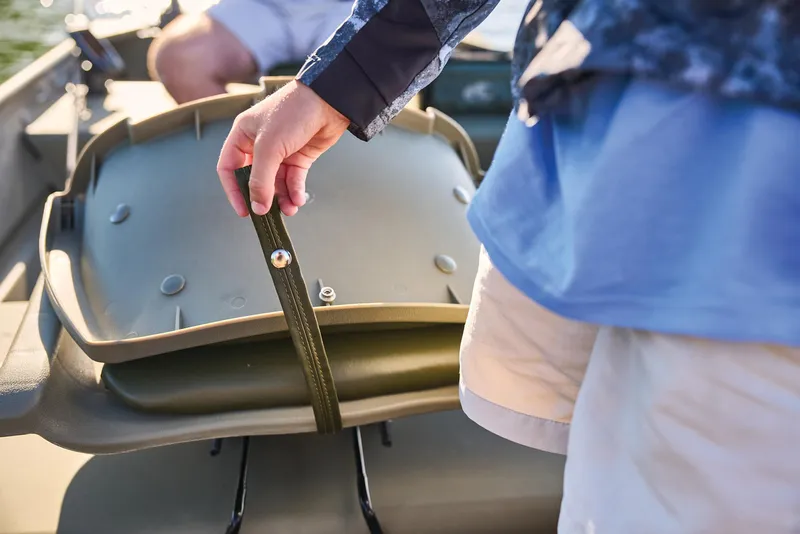 Slide: The Image of Manufacturer Provided Image: Person adjusting seat strap on 2026 Tracker Grizzly 12 Jon boat. - 25