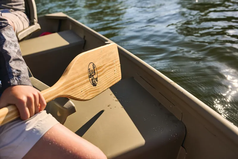 Slide: The Image of Manufacturer Provided Image: 2026 Tracker Grizzly 12 Jon boat with wooden paddle on calm water. - 27