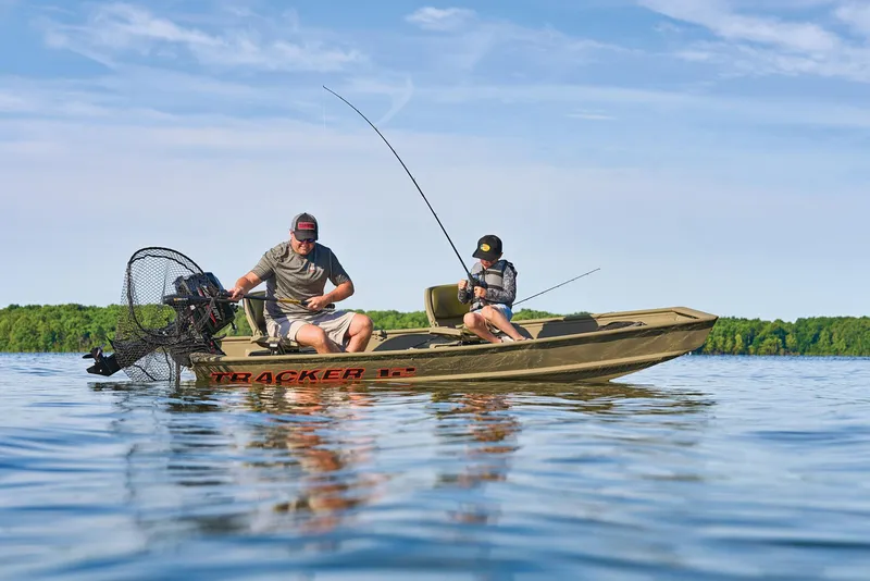 Slide: The Image of Manufacturer Provided Image: Two people fishing on a 2026 Tracker Grizzly 12 Jon boat in a serene lake. - 28