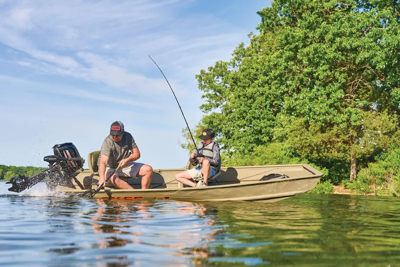 Slide: The Image of Manufacturer Provided Image: Two people fishing on a 2026 Tracker Grizzly 12 Jon boat in a serene lake. - 29