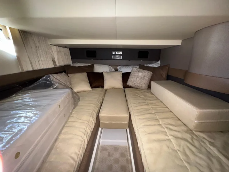 Slide: The Image of Luxurious interior of 2014 Marquis 420 Sport Bridge yacht with beige bedding and cushions. - 10