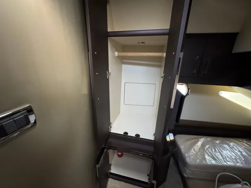 Slide: The Image of 2014 Marquis 420 Sport Bridge interior closet with open doors and storage space. - 11