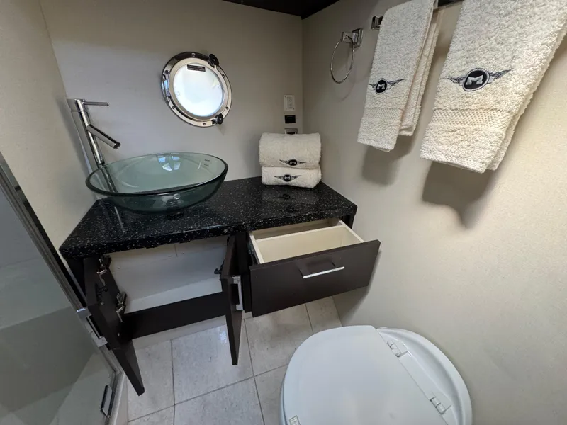 Slide: The Image of Luxurious bathroom in 2014 Marquis 420 Sport Bridge yacht with glass sink and elegant towels. - 17
