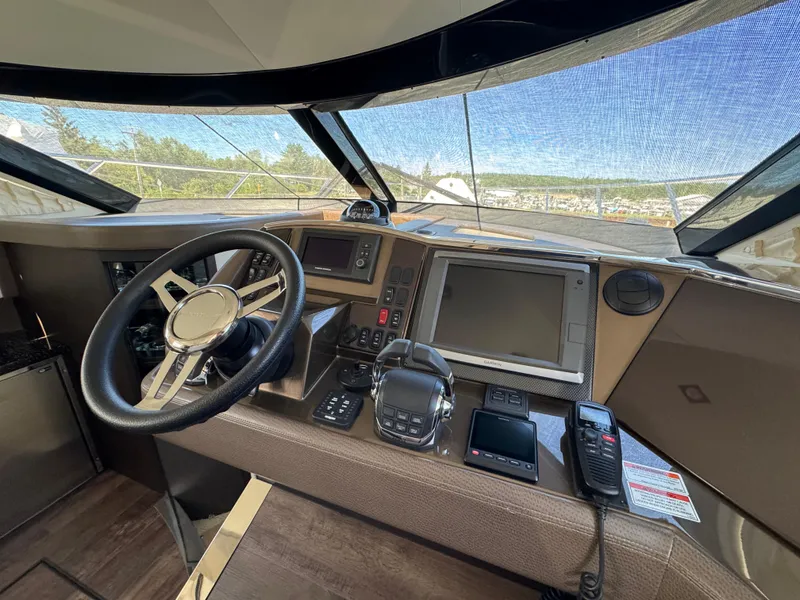 Slide: The Image of 2014 Marquis 420 Sport Bridge helm with steering wheel, navigation screens, and controls. - 19