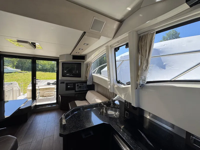 Slide: The Image of Interior of 2014 Marquis 420 Sport Bridge yacht with modern design and large windows. - 21