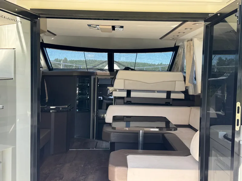 Slide: The Image of Interior of 2014 Marquis 420 Sport Bridge yacht with modern seating and sleek design. - 24