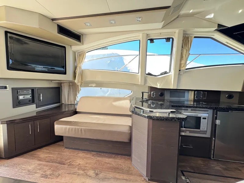Slide: The Image of Luxurious interior of 2014 Marquis 420 Sport Bridge yacht with modern kitchen and seating area. - 29