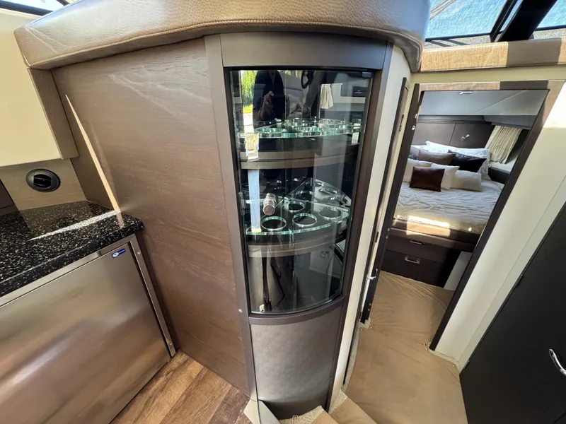 Slide: The Image of Luxurious interior of 2014 Marquis 420 Sport Bridge yacht with glass cabinet and cozy bedroom. - 34