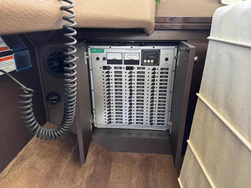 Slide: The Image of Electrical control panel inside 2014 Marquis 420 Sport Bridge yacht, featuring multiple switches and gauges. - 35