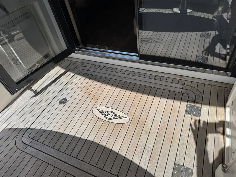 Slide: The Image of Teak deck of 2014 Marquis 420 Sport Bridge yacht with logo and shadow. - 36