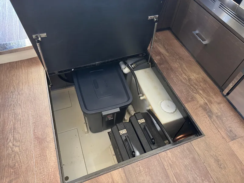 Slide: The Image of Storage compartment in 2014 Marquis 420 Sport Bridge yacht, featuring utility boxes and equipment. - 37