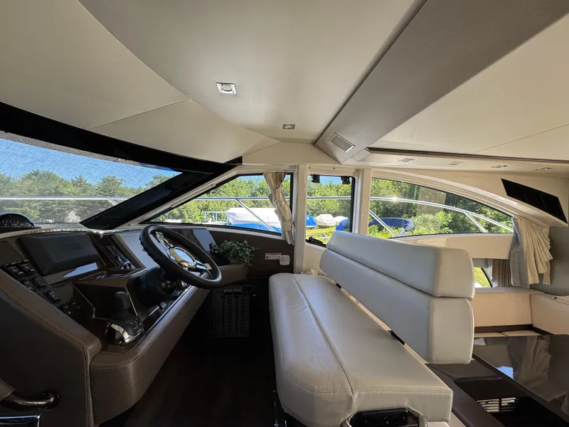 Slide: The Image of Interior of 2014 Marquis 420 Sport Bridge yacht with modern helm and seating. - 38