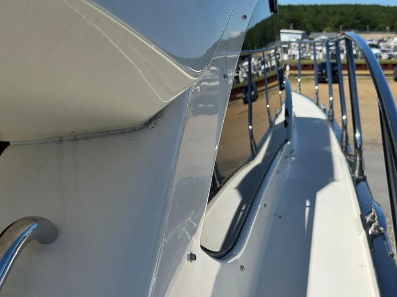 Slide: The Image of 2014 Marquis 420 Sport Bridge yacht deck with railing, docked at marina. - 39