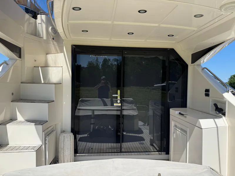 Slide: The Image of 2014 Marquis 420 Sport Bridge yacht interior with stairs and glass doors. - 41