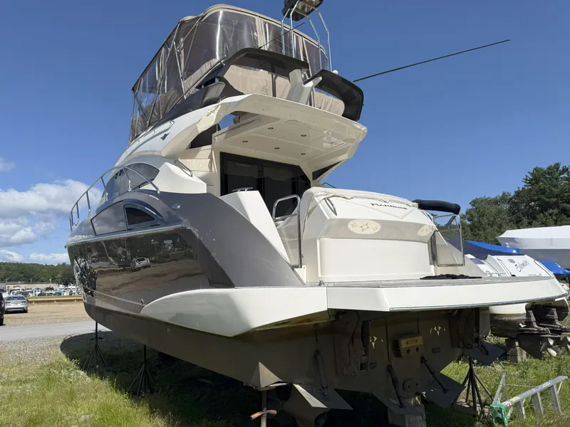 Slide: The Image of 2014 Marquis 420 Sport Bridge yacht on land, showcasing sleek design and spacious deck. - 42