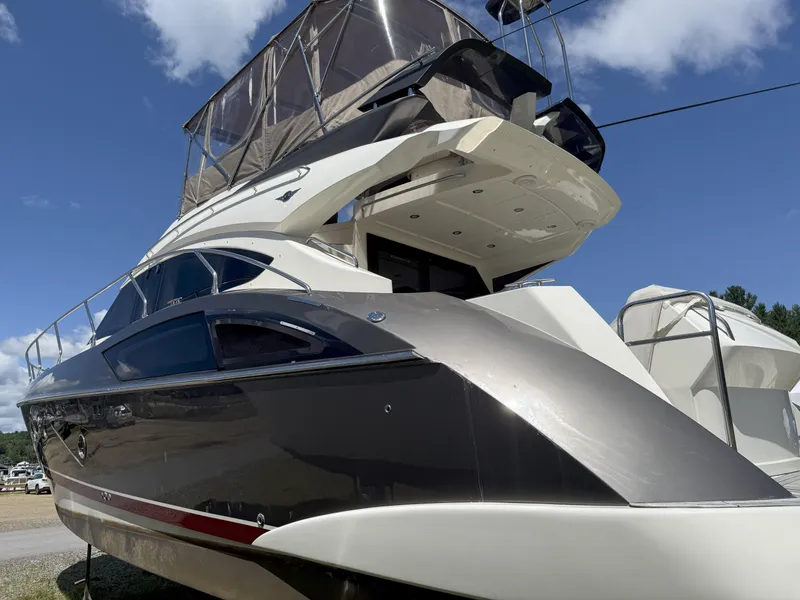 Slide: The Image of 2014 Marquis 420 Sport Bridge yacht with sleek design under a clear blue sky. - 43