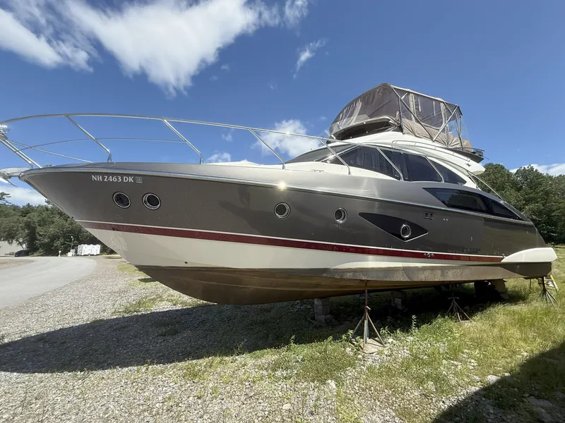 Slide: The Image of 2014 Marquis 420 Sport Bridge yacht on land under a clear blue sky. - 44