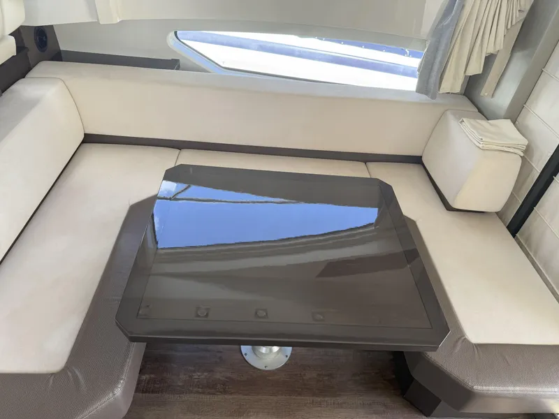 Slide: The Image of Interior of 2014 Marquis 420 Sport Bridge with sleek seating and glass table. - 45