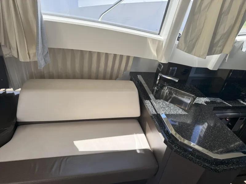 Slide: The Image of Interior of 2014 Marquis 420 Sport Bridge with sofa and sleek kitchen counter. - 47