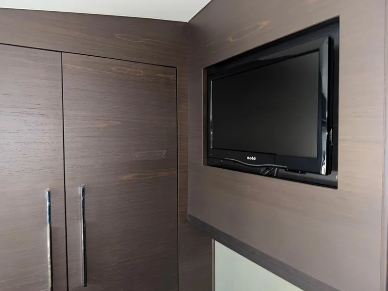 Slide: The Image of Wall-mounted TV and wooden cabinet in 2014 Marquis 420 Sport Bridge yacht interior. - 8