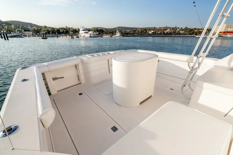 Slide: The Image of Spacious deck of 2002 Cabo 35 Flybridge yacht in a serene marina setting. - 10