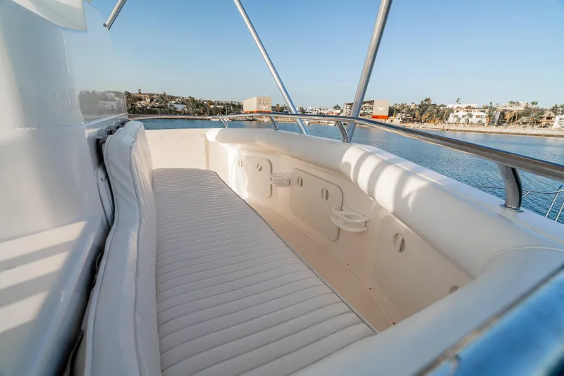 Slide: The Image of 2002 Cabo 35 Flybridge boat with spacious seating area and scenic waterfront view. - 15
