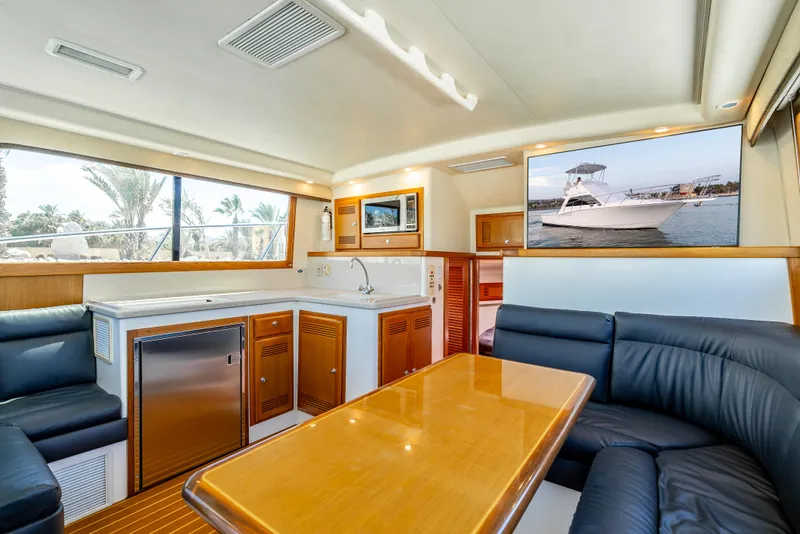 Slide: The Image of Luxurious interior of 2002 Cabo 35 Flybridge yacht with modern amenities and elegant seating. - 19