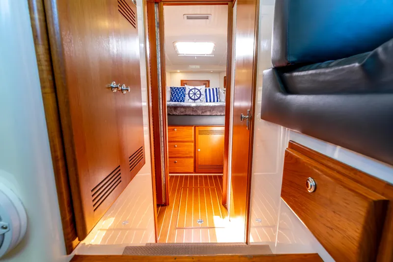 Slide: The Image of Interior of 2002 Cabo 35 Flybridge yacht with wooden cabinetry and nautical-themed decor. - 22