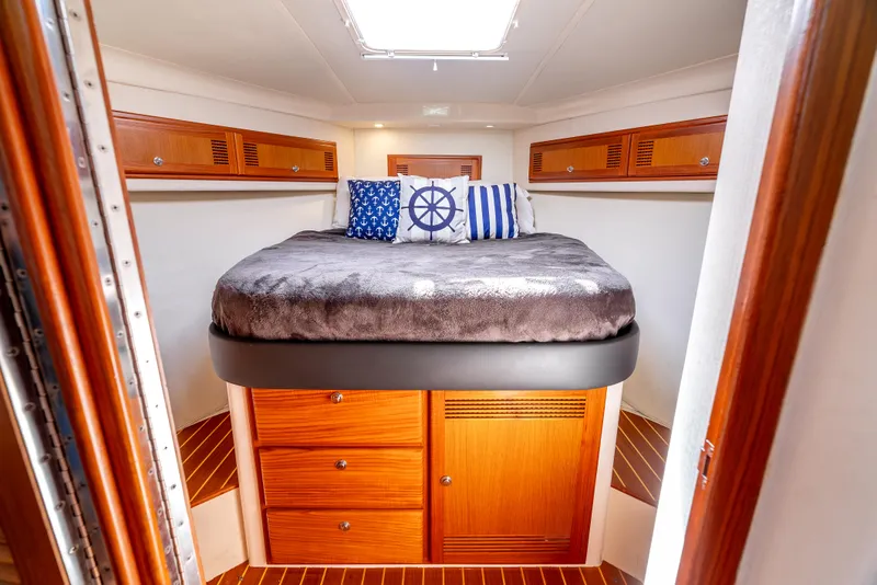 Slide: The Image of Luxurious cabin interior of 2002 Cabo 35 Flybridge with nautical-themed decor. - 23