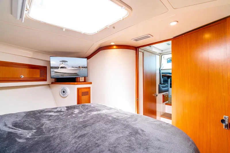 Slide: The Image of Interior of 2002 Cabo 35 Flybridge yacht with cozy bedroom and TV. - 25