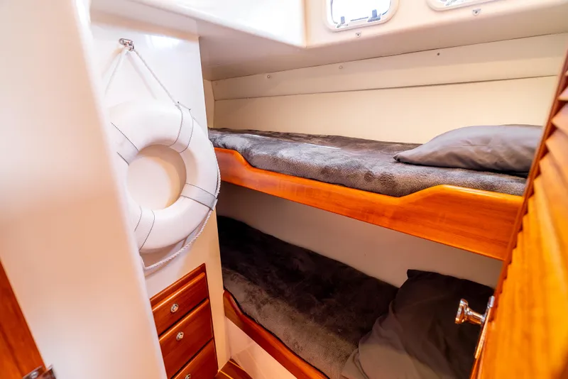 Slide: The Image of Cozy bunk beds in 2002 Cabo 35 Flybridge cabin with life preserver. - 27