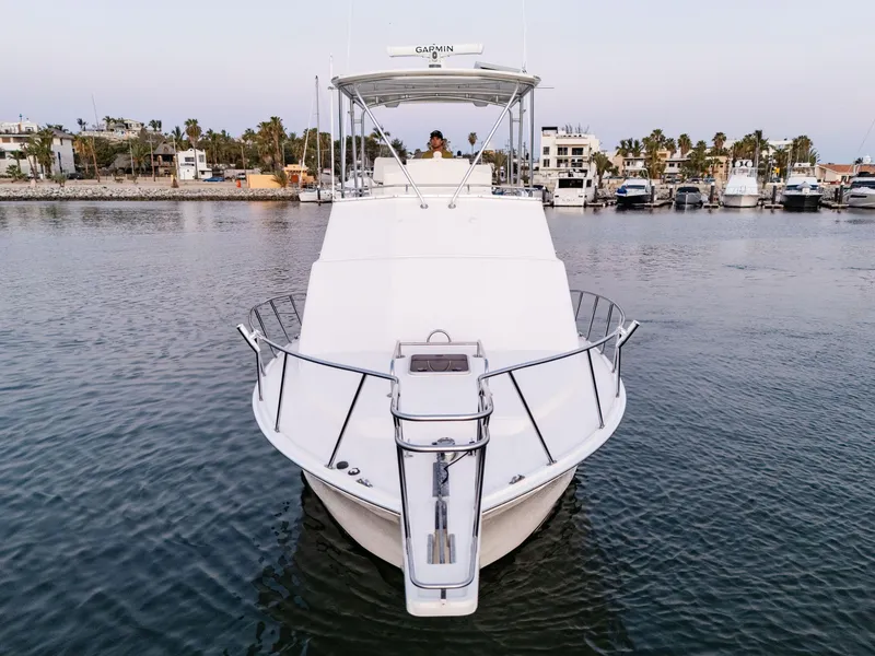 Slide: The Image of 2002 Cabo 35 Flybridge yacht docked in a marina, front view. - 3